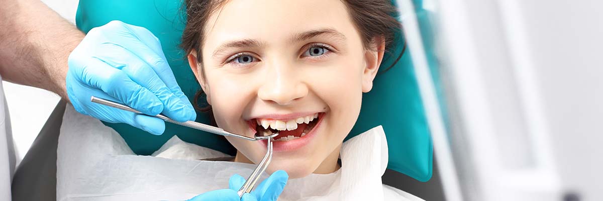 Little girl having teeth checked